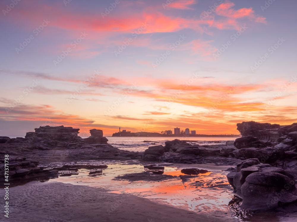 Colourful Seaside Sunrise with Cloud Reflections