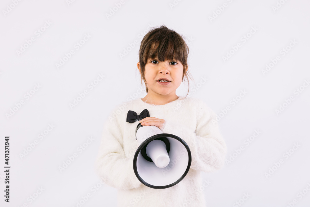 Little black haired girl wearing white sweater with bow tie, speaking through a white megaphone. Little black haired girl wearing white sweater with bow tie, speaking through a white megaphone.