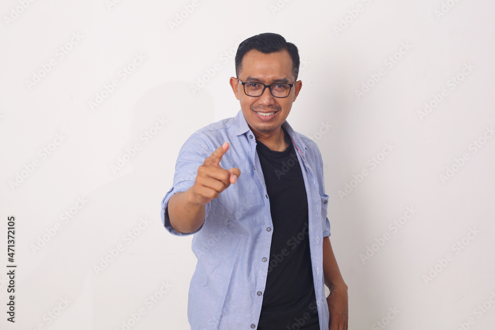 Asian man pointing forward, Looking at Camera, make choosing you gesture. Isolated on white backgrund Asian man pointing forward, Looking at Camera, make choosing you gesture. Isolated on white backgrund