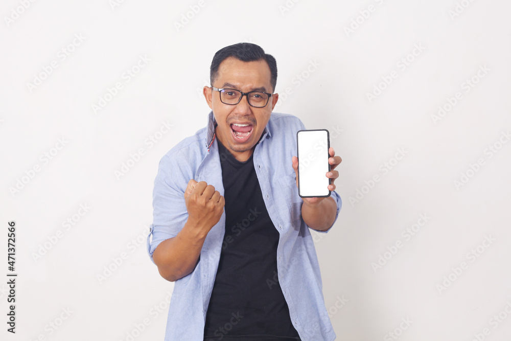 Portrait of shocked asian man in casual showing blank screen of cellphone and looking at camera with amazement expression. Isolated on white Portrait of shocked asian man in casual showing blank screen of cellphone and looking at camera with amazement expression. Isolated on white