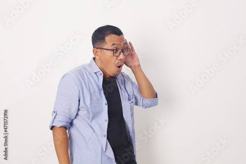 Asian Man Listening rumor or gossip carefully. Deafness concept. Isolated on white background