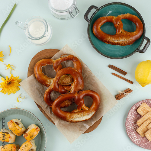 Freshly Baked Homemade Soft Pretzel (Bavarian Brezel) with Salt on Pastel Mint Table. Perfect for Octoberfest. Top View with Copy Space photo