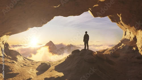 Adventurous Man Hiker standing in a cave with rocky mountains in background. Adventure Composite. 3d Rendering Peak. Aerial Image of landscape from British Columbia, Canada. Sunset Cloudy Sky photo