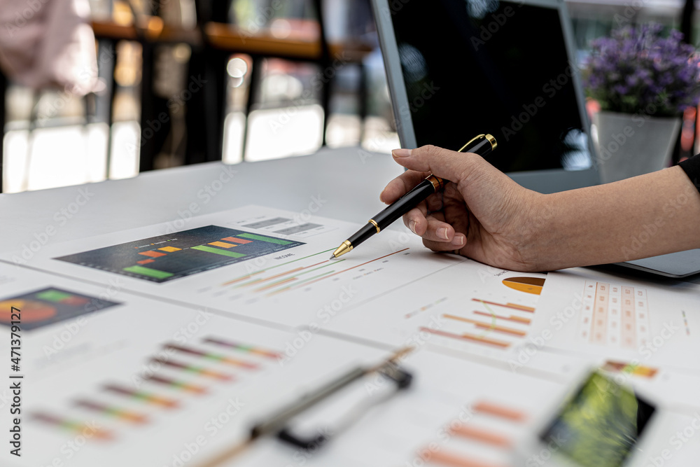 A business finance woman is reviewing a company's financial documents prepared by the Finance Department for a meeting with business partners. Concept of validating the accuracy of financial numbers. A business finance woman is reviewing a company's financial documents prepared by the Finance Department for a meeting with business partners. Concept of validating the accuracy of financial numbers.