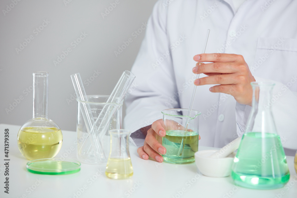 Plants extract in petri dish and a white background in laboratory , color liquid in a test tube and doctor for cosmetic advertising , photography science concept Plants extract in petri dish and a white background in laboratory , color liquid in a test tube and doctor for cosmetic advertising , photography science concept