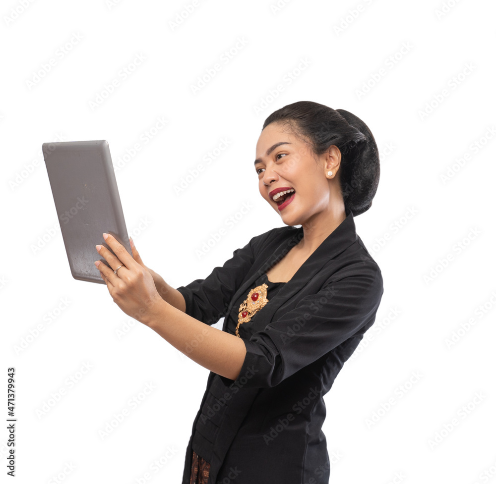 happy asian woman with kebaya using tablet computer happy asian woman with kebaya using tablet computer