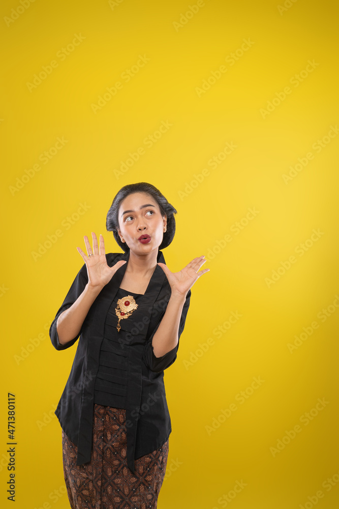 woman with Kebaya dress with surprised gesture with both palms open woman with Kebaya dress with surprised gesture with both palms open