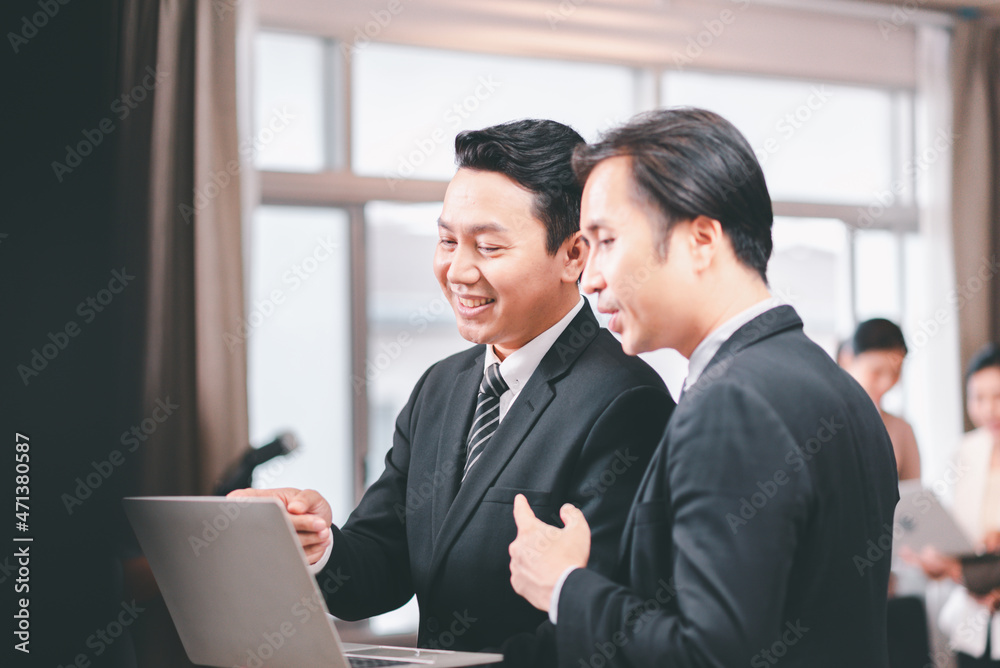 Asian businessman using laptop for working online at workplace Asian businessman using laptop for working online at workplace