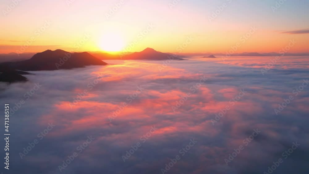 4K Aerial video Beautiful sunrise above dense clouds and fog in the morning, Cinematic drone shot.
4K Aerial video Beautiful sunrise above dense clouds and fog in the morning, Cinematic drone shot.