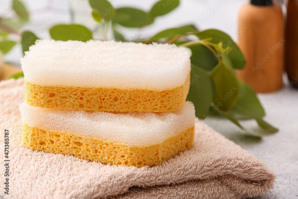 Bath sponges and towel on table, closeup Bath sponges and towel on table, closeup