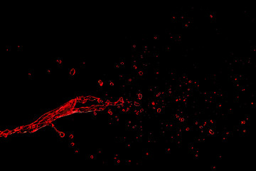Splash of red liquid on black background
