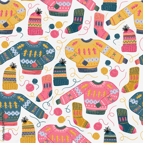Needlework seamless pattern with sweater, knitting hat, sock and woolen tangles. Hand made clothes. photo