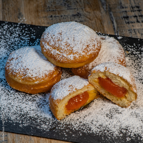 Freshly cooked Apricot jam doughnuts, referred to as jelly doughnuts, donuts in the US