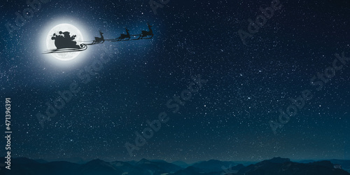 silhouette of a flying goth santa claus against the background of the christmas night sky.