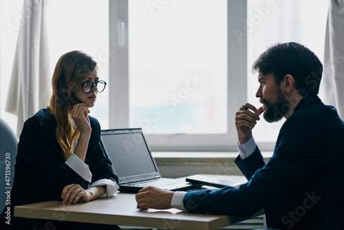 colleagues sitting in front of a laptop teamwork internet technologies