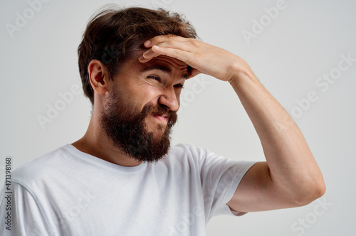 bearded man in a white t-shirt headache migraine problems Studio treatment