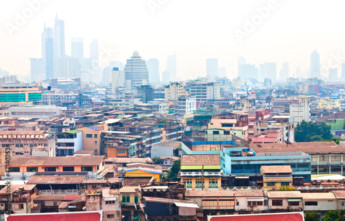 A wide panoramic view of old Bangkok and skyscrapers as background