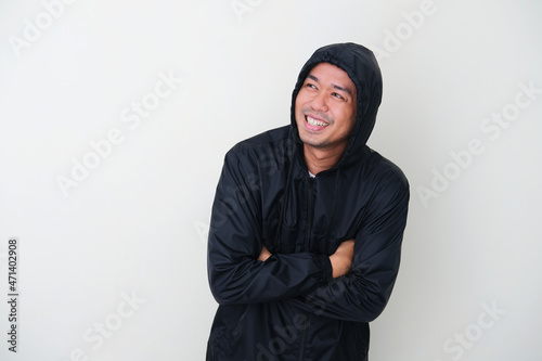 Adult Asian man wearing black jacket smiling happy during winter season photo