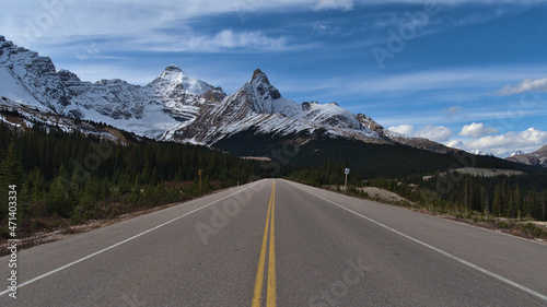 Diminishing perspective of famous Icefields Parkway (highway 93) in Banff National Park, Alberta, Canada in the Rocky Mountains with Mount Athabasca.