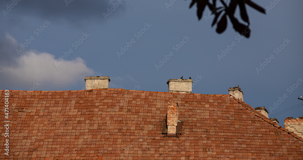 chimney on the roof of the house against the blue sky chimney on the roof of the house against the blue sky