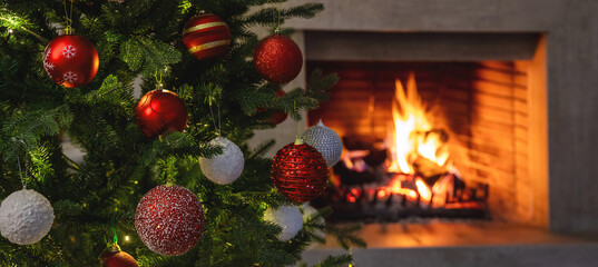 Christmas holiday home background. Warm cozy burning fireplace and Xmas tree decoration