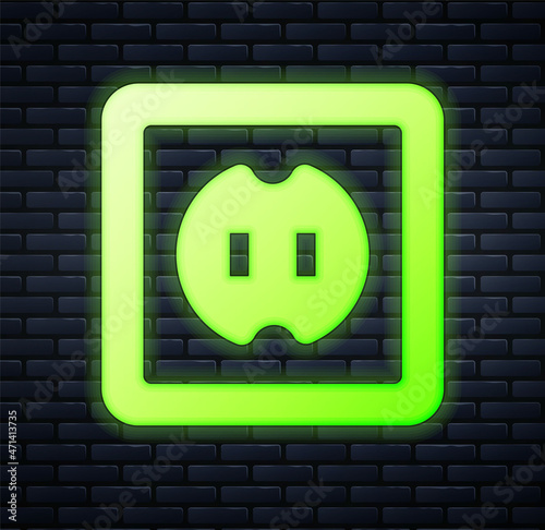 Glowing neon Electrical outlet icon isolated on brick wall background. Power socket. Rosette symbol. Vector