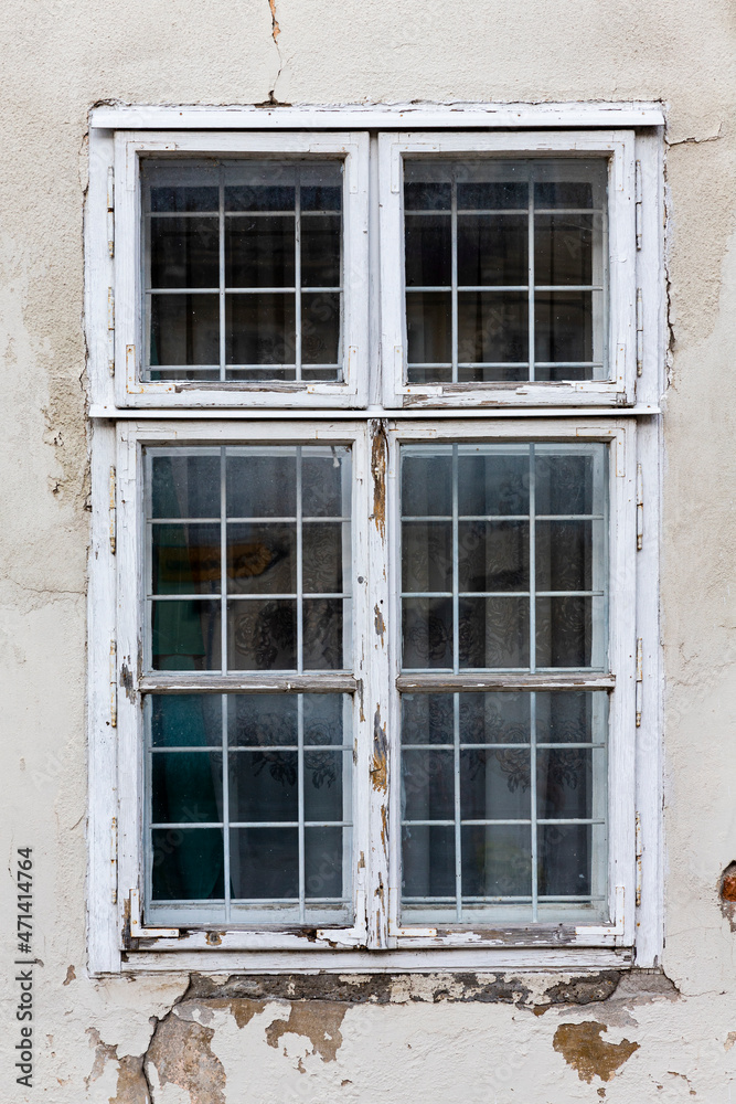 Old, vintage window with ruined and worn facade