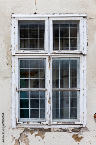 Old, vintage window with ruined and worn facade