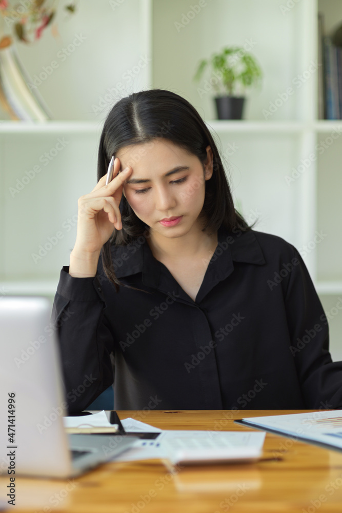 Thoughtful female manager stressed due to overwork Thoughtful female manager stressed due to overwork