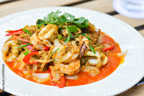 stir-fried seafood in curry powder, stir fried squid in yellow curry or Stir-fried squid and Stir-fried shrimp.