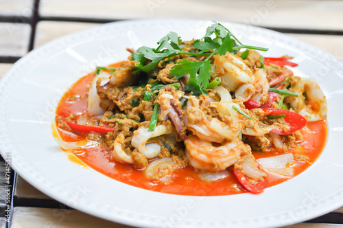 stir-fried seafood in curry powder, stir fried squid in yellow curry or Stir-fried squid and Stir-fried shrimp.
