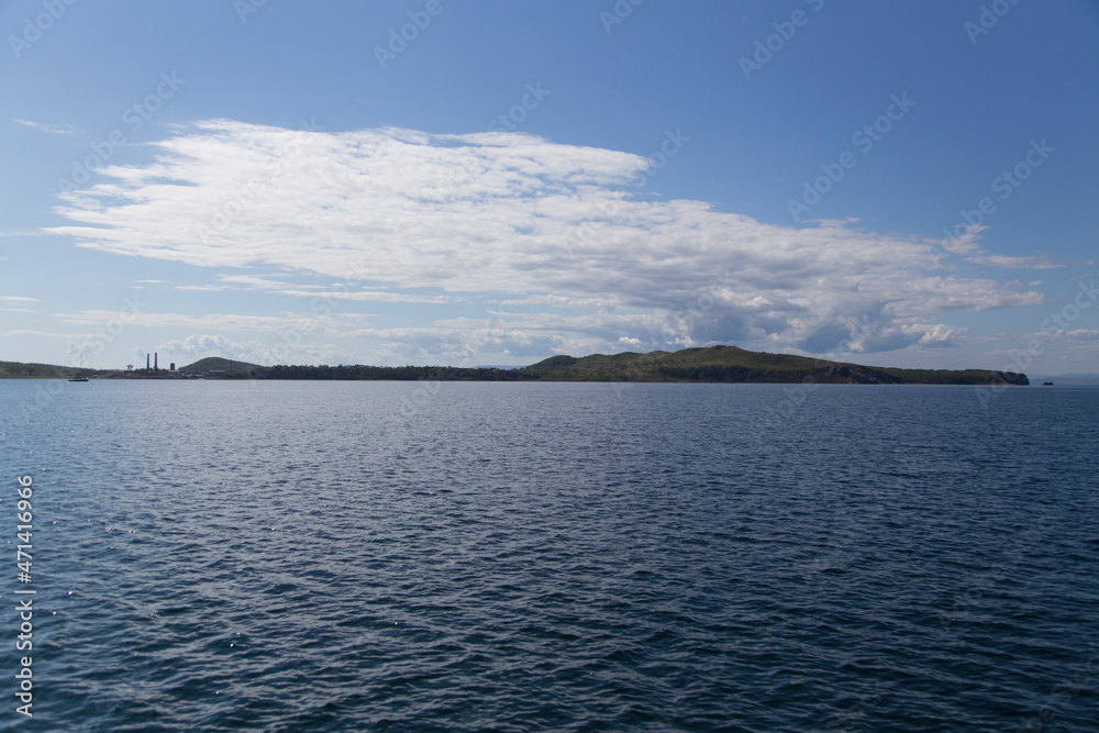 day view of the sea, islets, capes, white clouds and blue sky in the Novik harbor on island Russky in Vladivostok, Russia