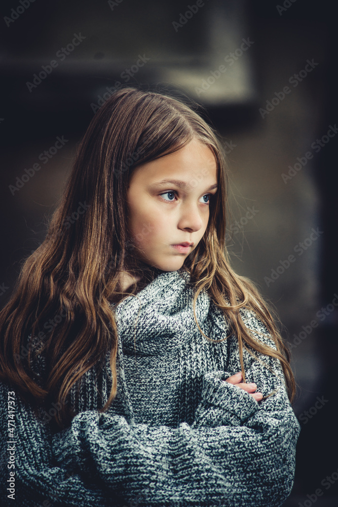 sad teenage girl in a warm sweater on a dark background sad teenage girl in a warm sweater on a dark background