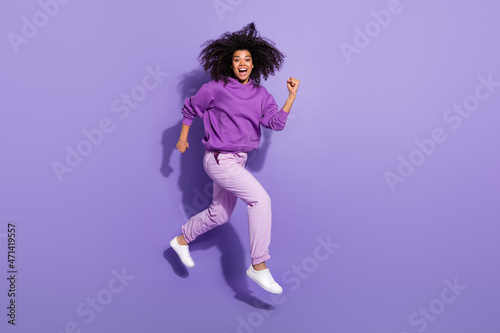 Full body profile portrait of afro hairstyle excited crazy lady hurry fast isolated on violet color background