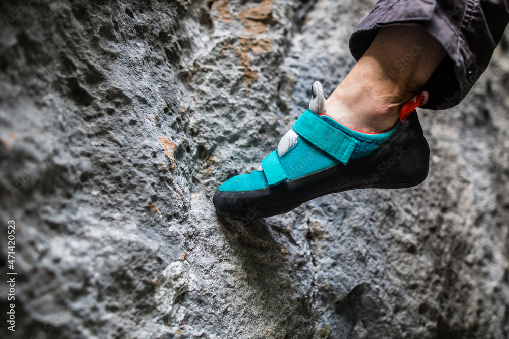 Person climbing while wearing rock climbing shoes Person climbing while wearing rock climbing shoes