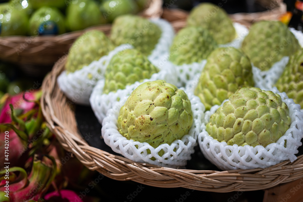 Group of premium big sugar apple or custard apple fruits is selling on shelf in supermarket. Food close-up object photo. Group of premium big sugar apple or custard apple fruits is selling on shelf in supermarket. Food close-up object photo.