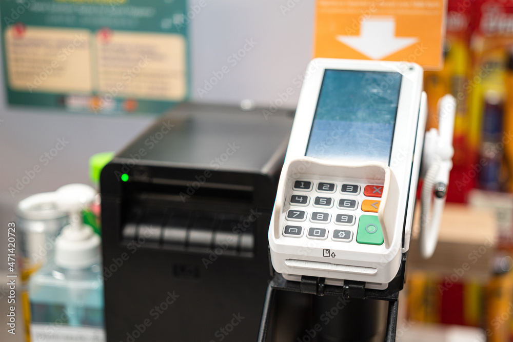Credit card reader on the counter payment service. Business and technology device object photo. Close-up and selective focus at the number key pad. Credit card reader on the counter payment service. Business and technology device object photo. Close-up and selective focus at the number key pad.
