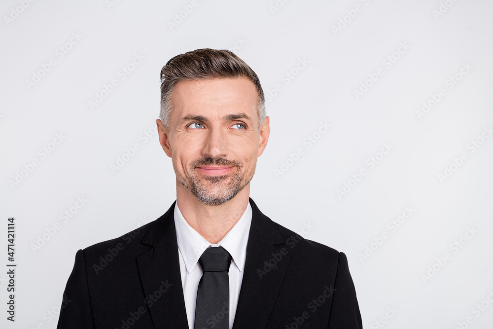 Photo of clever thoughtful mature broker dressed black suit looking empty space isolated grey color background Photo of clever thoughtful mature broker dressed black suit looking empty space isolated grey color background