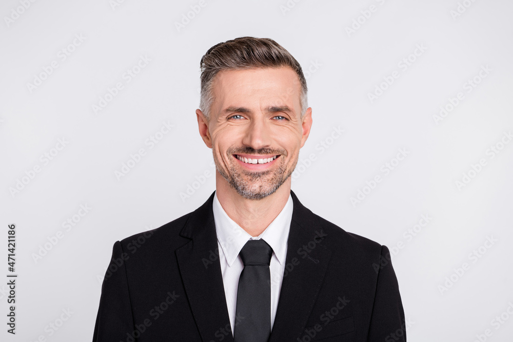 Photo of intelligent positive young executive wear black jacket smiling isolated grey color background Photo of intelligent positive young executive wear black jacket smiling isolated grey color background