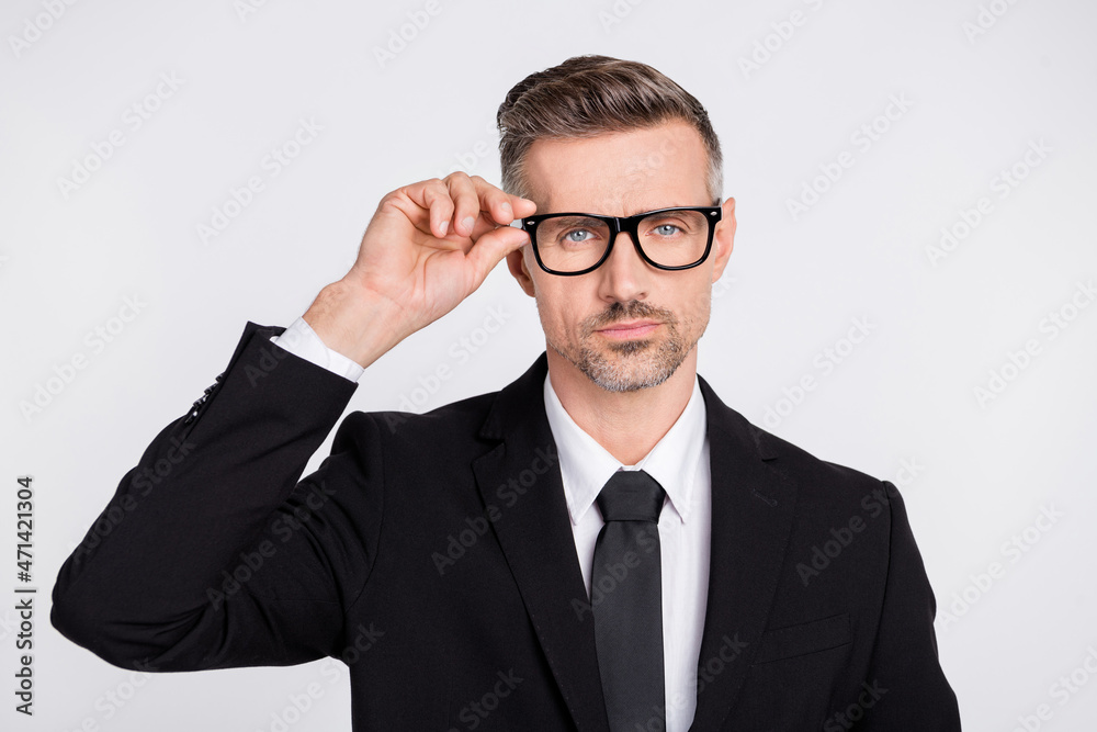 Photo of serious smart mature clerk dressed black suit arm glasses isolated grey color background Photo of serious smart mature clerk dressed black suit arm glasses isolated grey color background