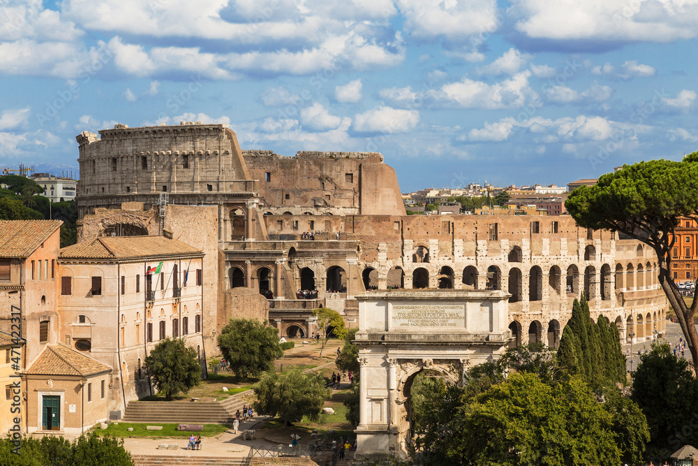 View of the Roman Forum with buildings, Arch of Titus and the Colosseum. Rome, Italy
