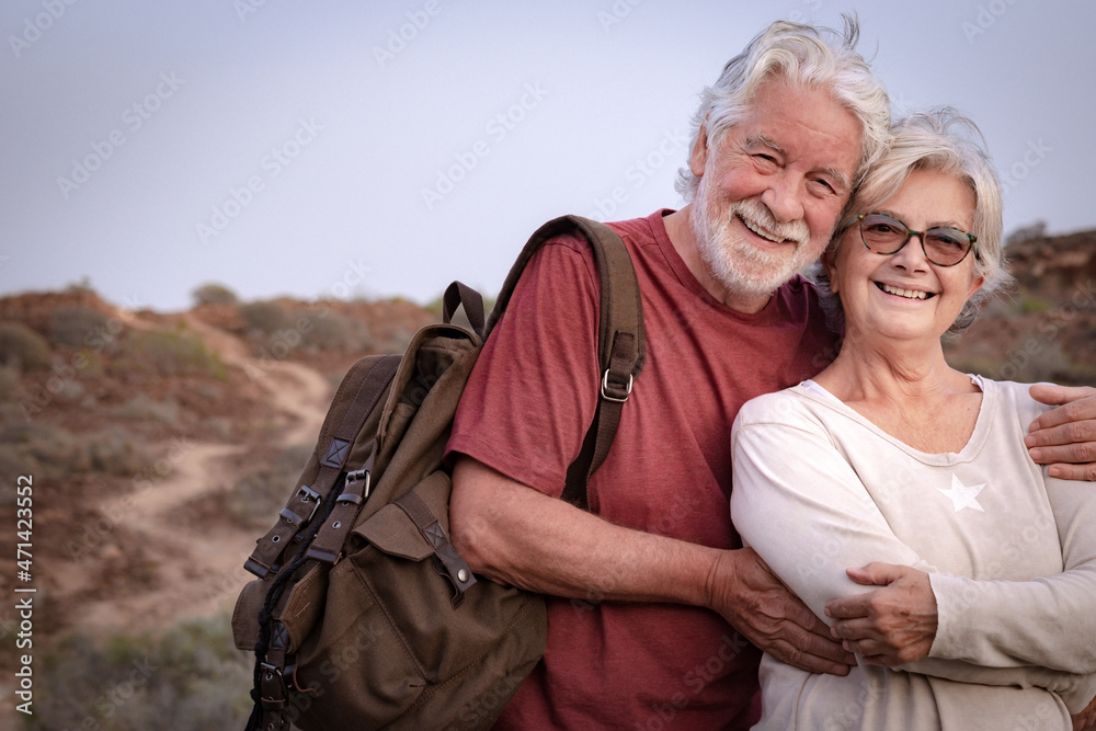Portrait of beautiful senior couple white-haired in outdoors excursion, active and healthy lifestyle