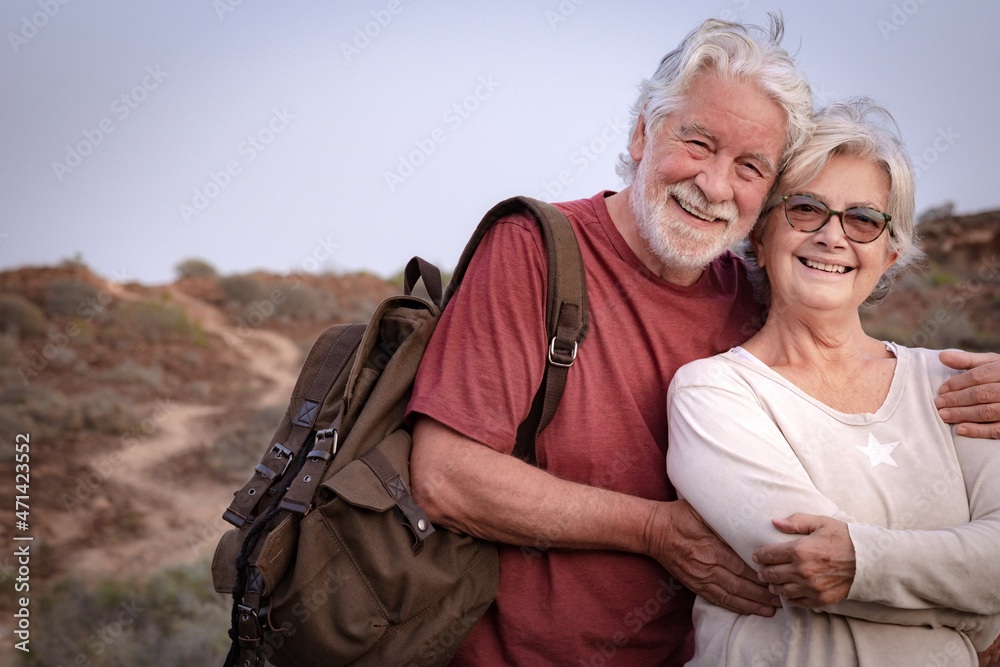Portrait of beautiful senior couple white-haired in outdoors excursion, active and healthy lifestyle Portrait of beautiful senior couple white-haired in outdoors excursion, active and healthy lifestyle