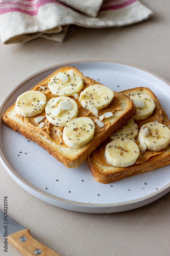 Sandwich with peanut butter, banana and chia seeds. Breakfast. Vegetarian food. Sandwich with peanut butter, banana and chia seeds. Breakfast. Vegetarian food.