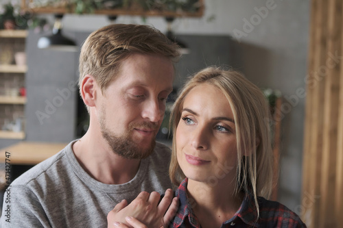 Closeup happy European couple hugging to each other enjoying perfect romantic relationship spending time together. Face of beautiful girlfriend and handsome boyfriend feeling love and tenderness
