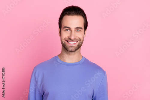 Photo of brunet optimistic young guy wear blue sweater isolated on pastel pink color background