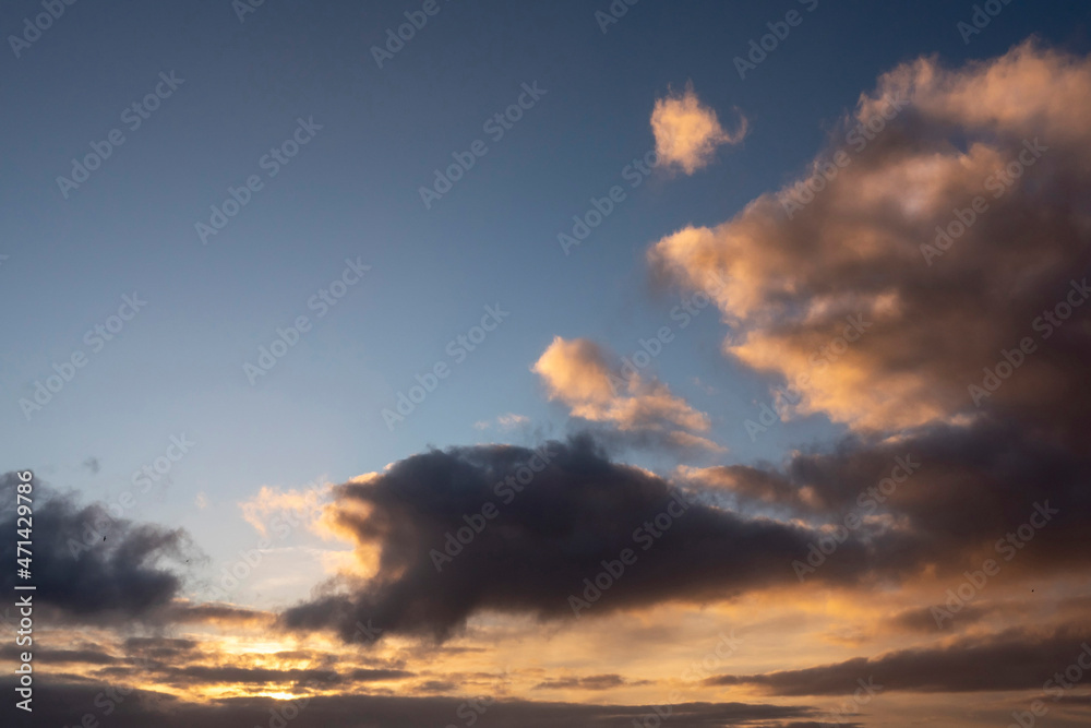 Dark dramatic sunset cloudy sky. Nature background. Warm and cool tone.