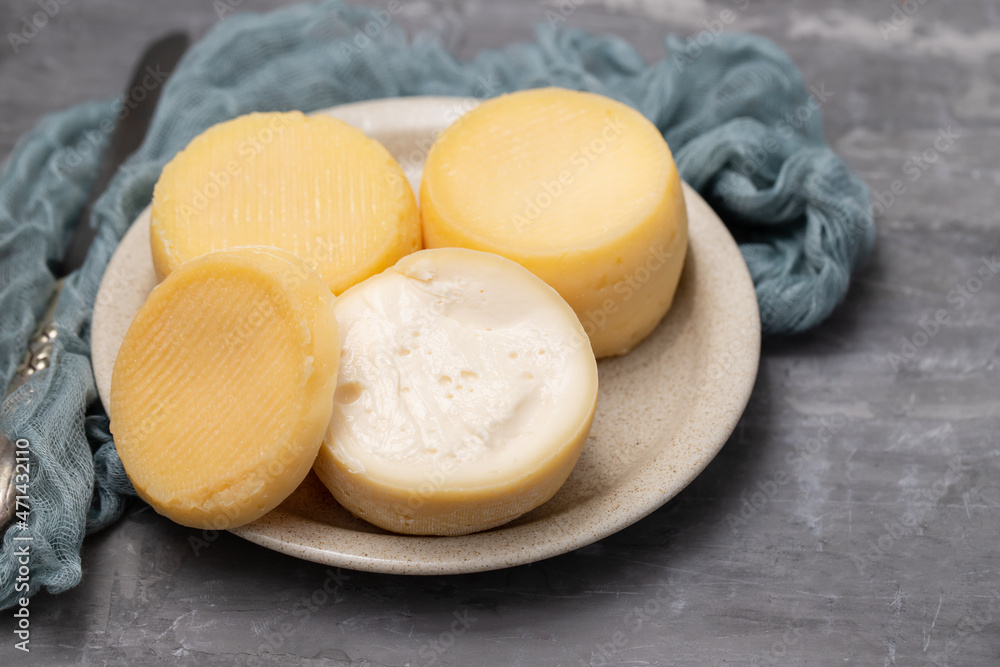 three fresh soft cheese on small dish on ceramic