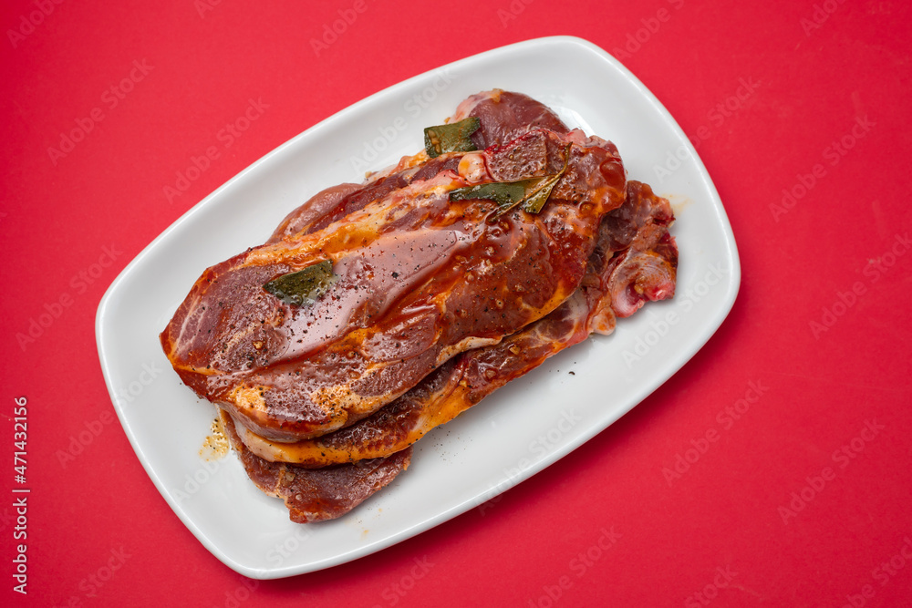 raw meat with marinate on white dish on ceramic raw meat with marinate on white dish on ceramic