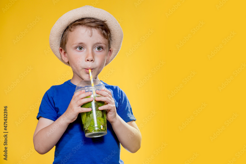 Summer refreshment. Cold beverage. Little boy with plastic cup of fresh lemonade Summer refreshment. Cold beverage. Little boy with plastic cup of fresh lemonade